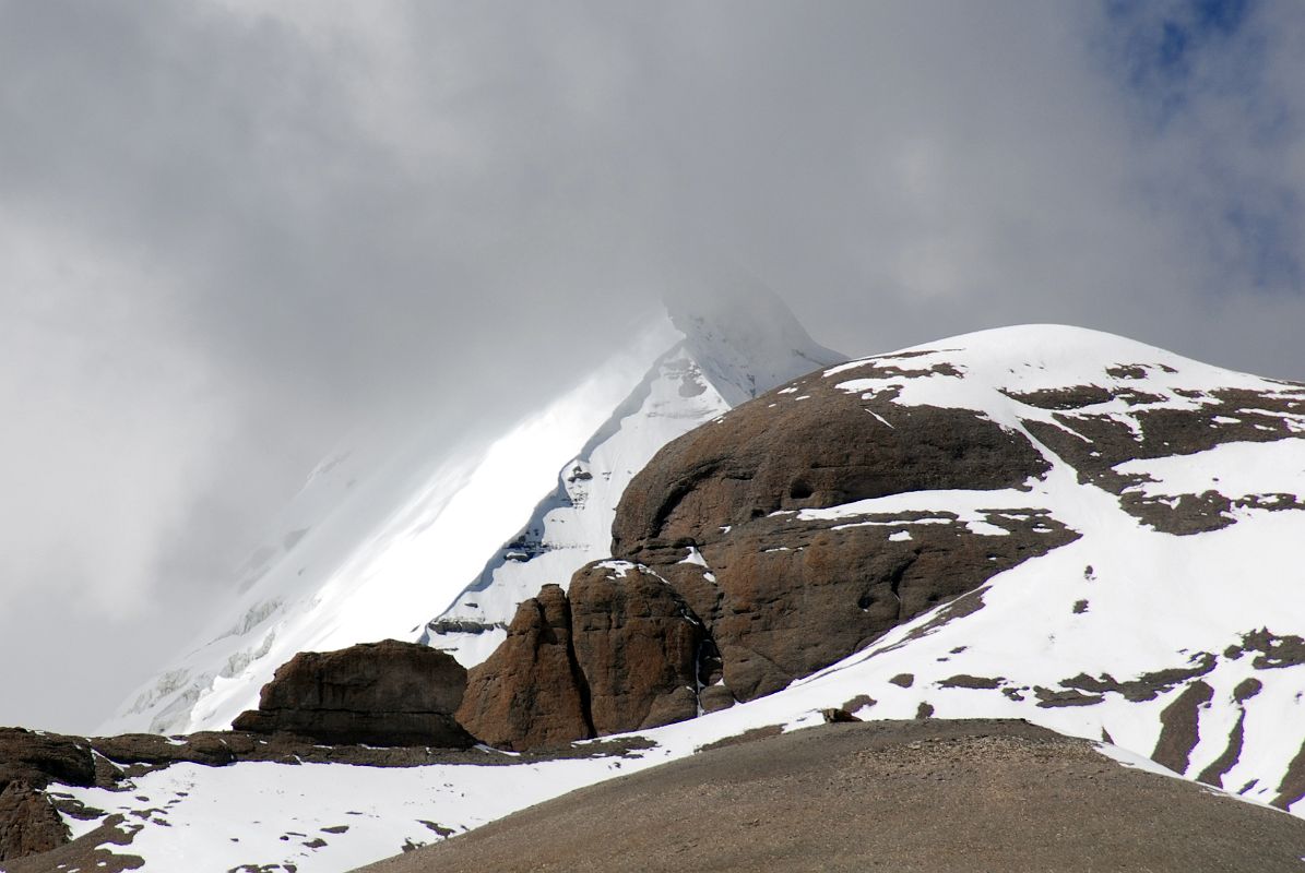 61 Mount Kailash South, East and North Faces From The Eastern Valley On Mount Kailash Outer Kora A bit more of the Kailash Eastern Face comes into view as the trail descends the Eastern Valley. The Kailash South Face is to the left and a bit of the North Face is to the right.